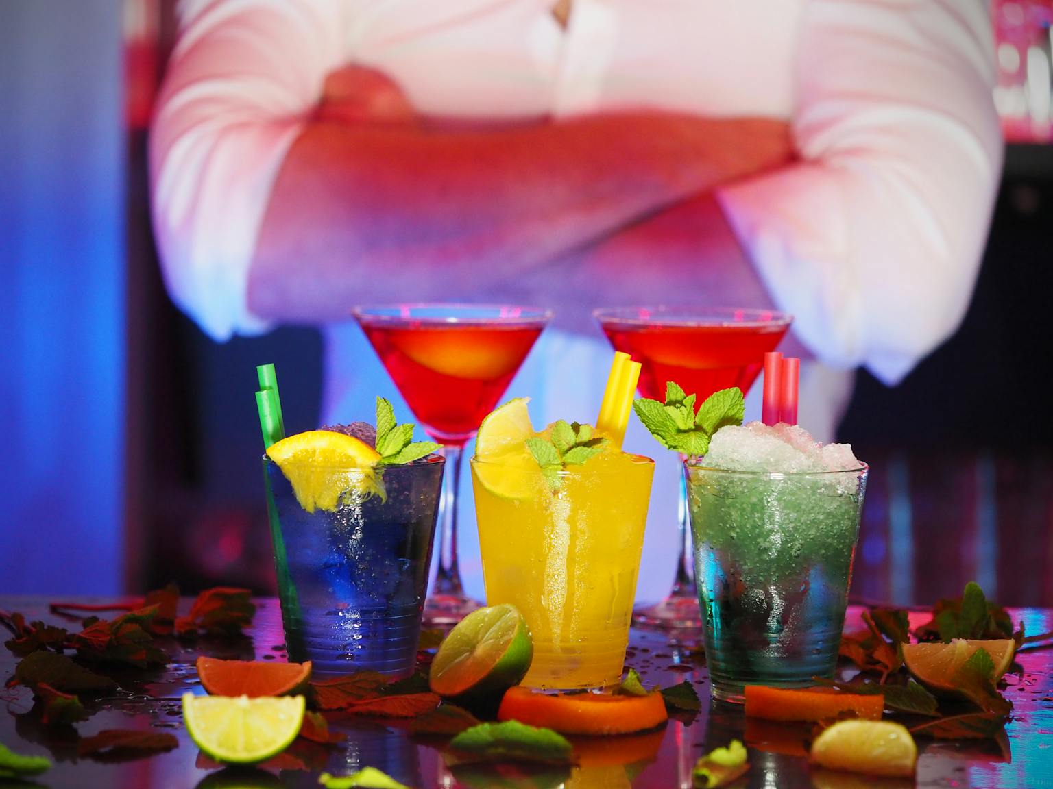 Colorful cocktails with citrus slices on a bar